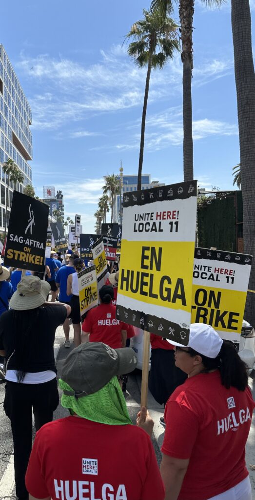 A group of picketers with signs from various unions.