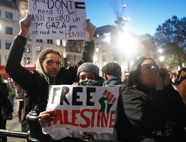 On Saturday 14 October thousands of people demonstrated in London in solidarity with Palestinians. The photo shows two young protesters. One is holding a black and red “Free Palestine” sign. The second is holding a sign which reads: “You don’t need to be Muslim to stand up for Gaza, you just need to be human.”