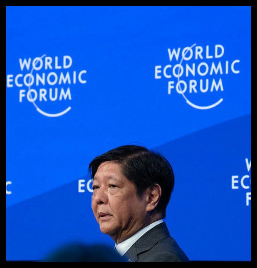 Ferdinand Marcos Jr, President of the Philippines at the World Economic Forum Annual Meeting January 2023 in Davos-Klosters, Switzerland. He is wearing a blue suit and standing in front of a screen with the repeating phrase, “World Economic Forum.”