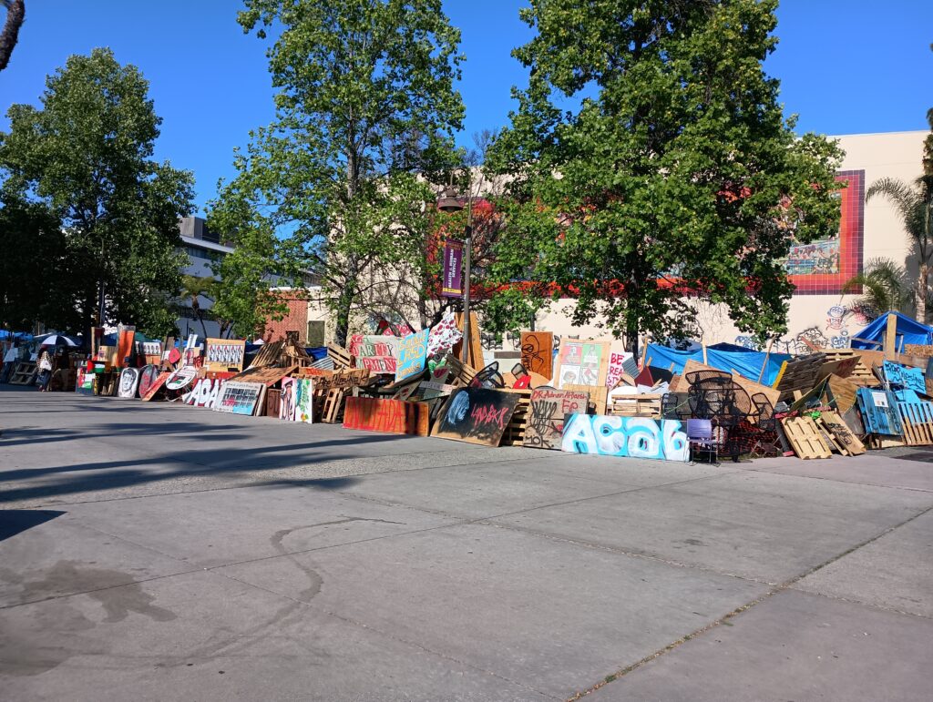 a set of tents and artwork proclaiming support for Palestine