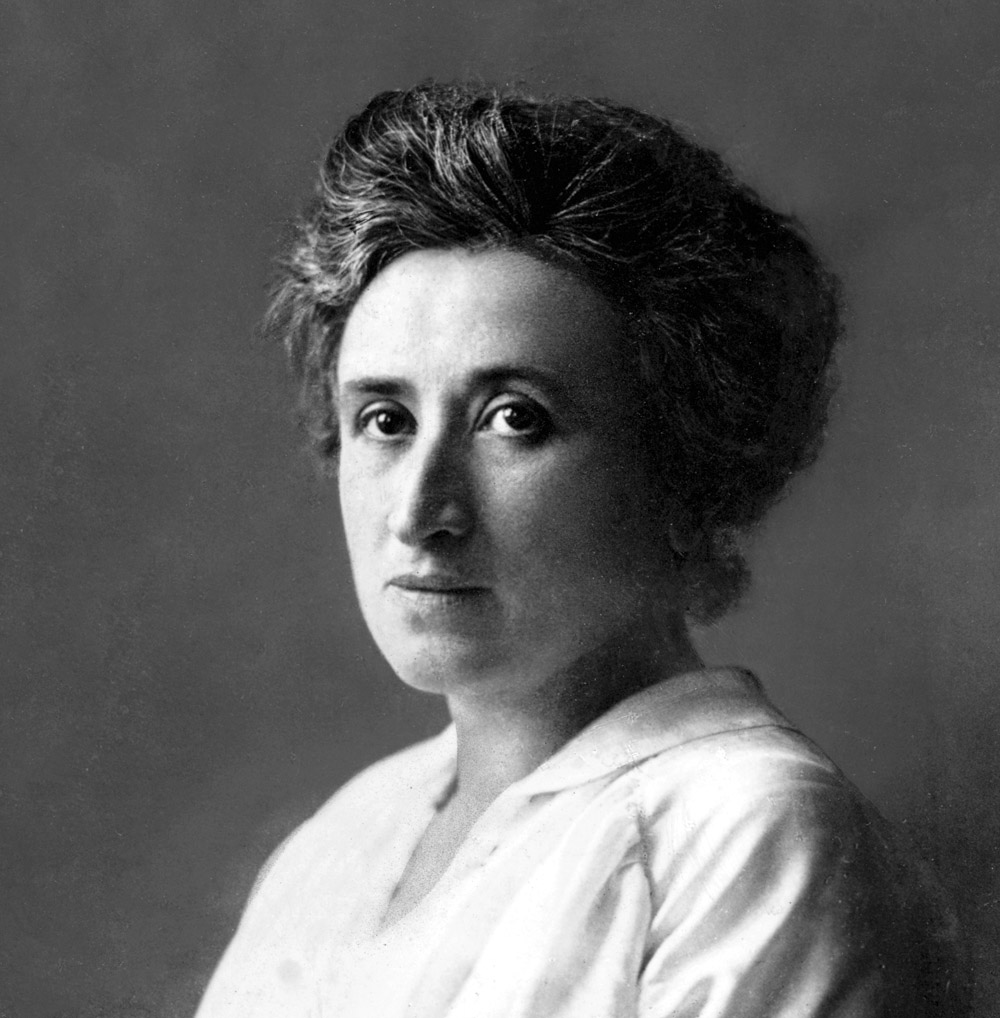 Black and white head-and-shoulders portrait of a woman, dressed in a white blouse, in three-quarter profile.
