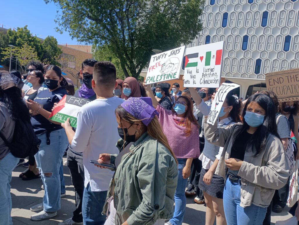 a group of protesters carrying signs calling for an end to Israel's war on Gaza