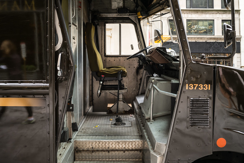 An eerie view into the empty and battered cab of a UPS delivery truck