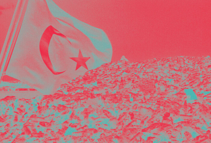 A Turkish flag flies over a waste dump, on a red background