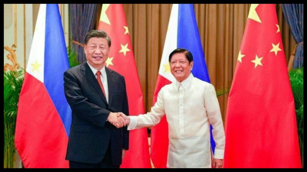 From right to left, President Xi of China shaking hands with President Marcos of the Philippines with flags of both nations behind them.