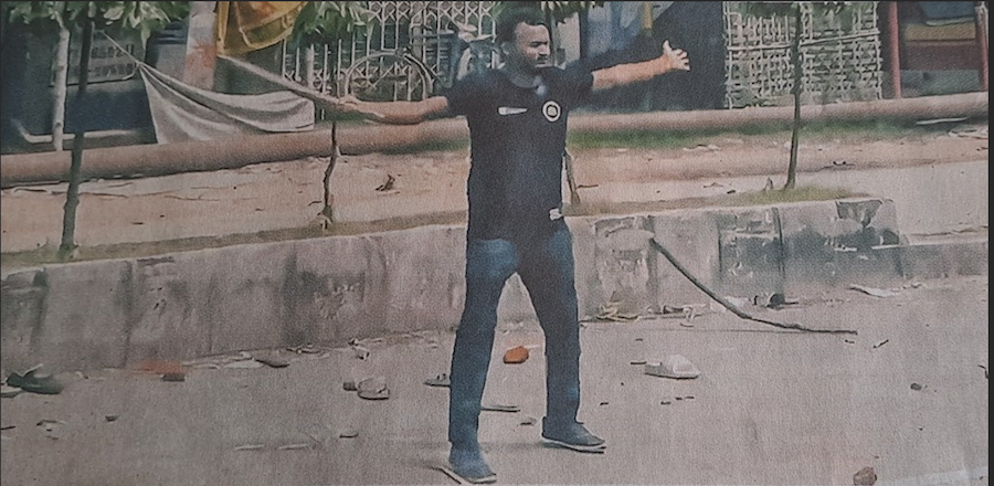 Dhaka University student, Abu Sayeed, with arms spread wide, immediately prior to his shooting by police. Photo from the Bangladeshi newspaper, Prothom Alo.