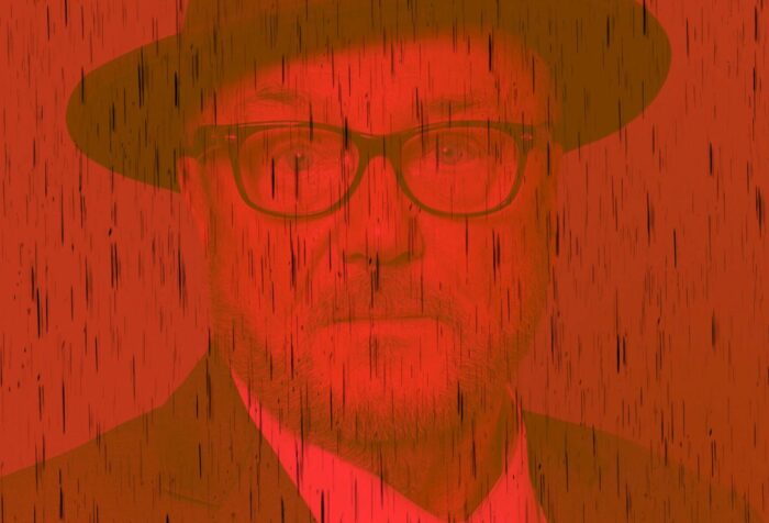 A headshot of George Galloway with a dark red tint over it.