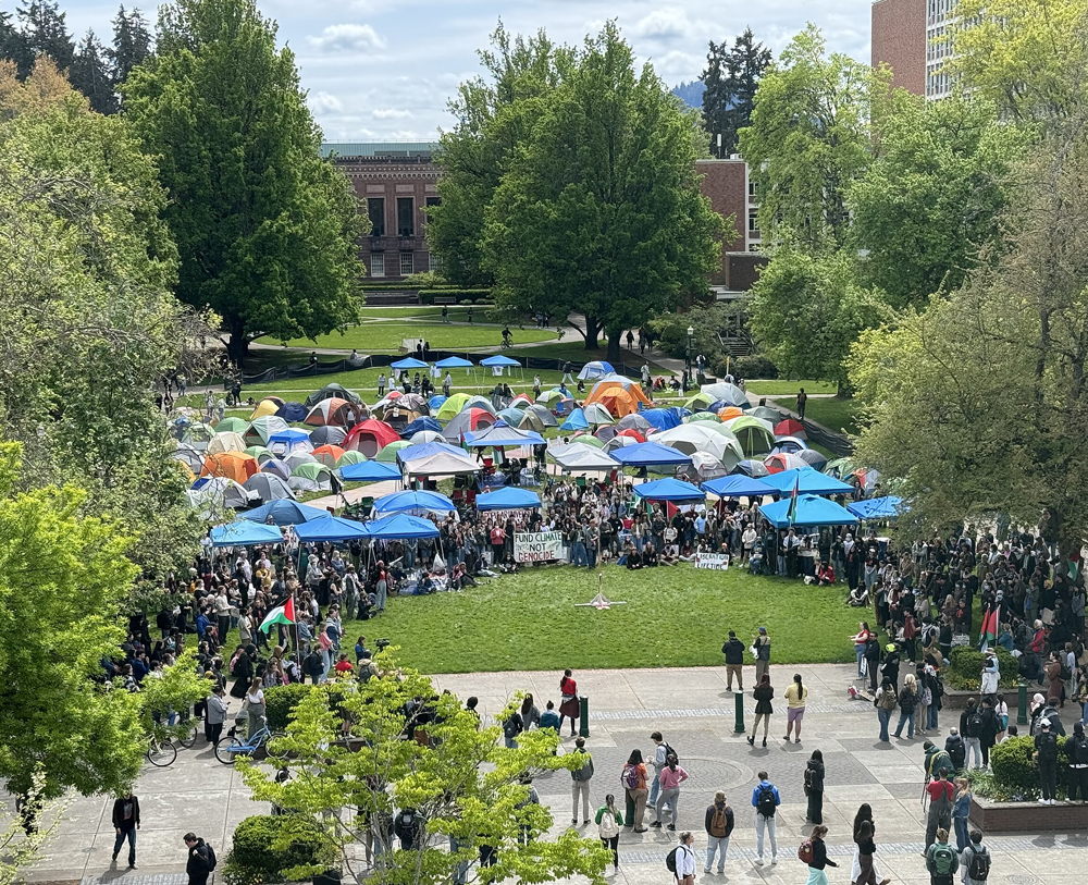 Aerial shot of a campus quad filled with people and tents.