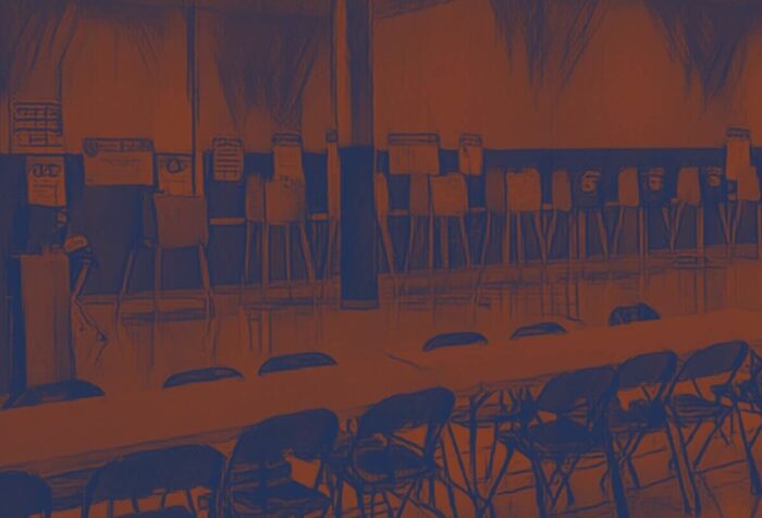 Photo of an empty polling center, with a dark orange and blue filter.