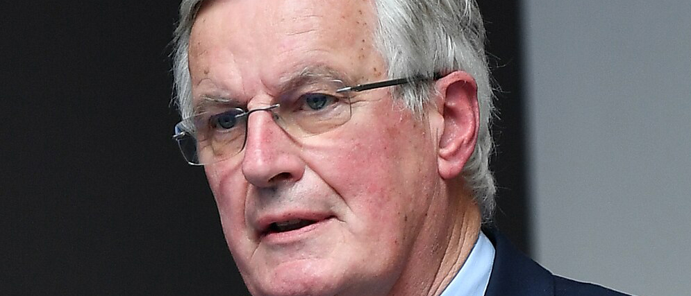  Tight color head shot of an elegant white-haired man, Michel Barnier. 