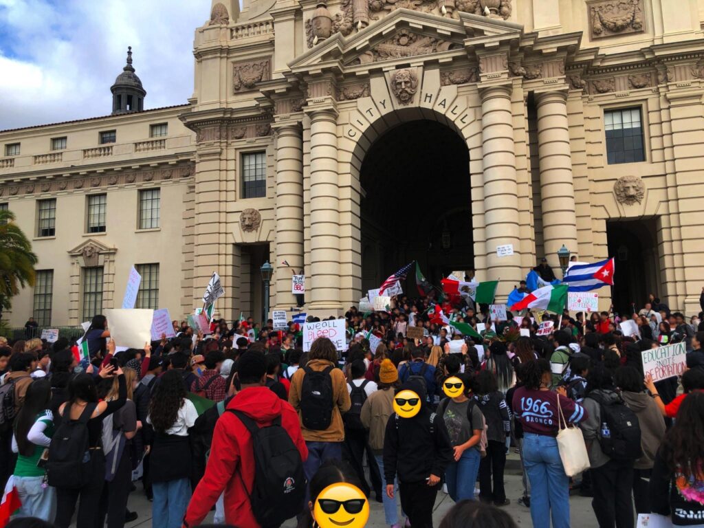 Lareg group of Pasadena high school students arrive a city hall carrying placards for the February 7, 2025 walkout and protest. 