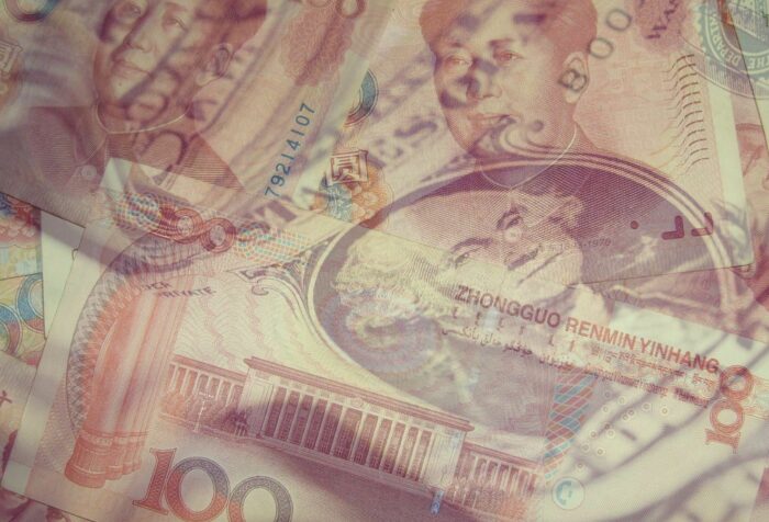 US dollar bills and Chinese yuan bills overlap.