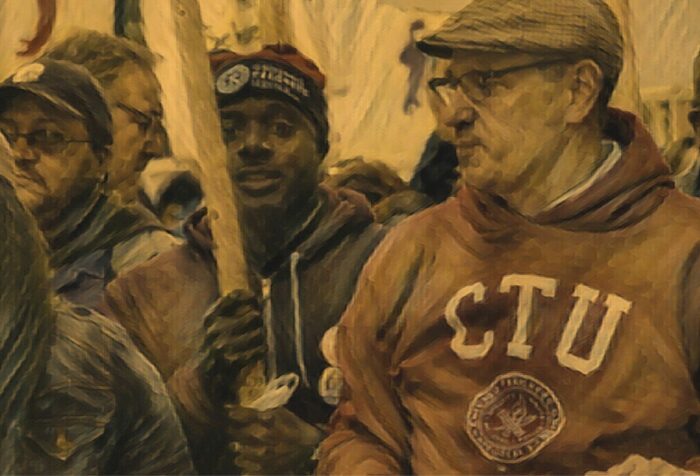 A close-up of a crowd of people at a march. One wears a sweatshirt that says CTU on it, another holds a signpole.