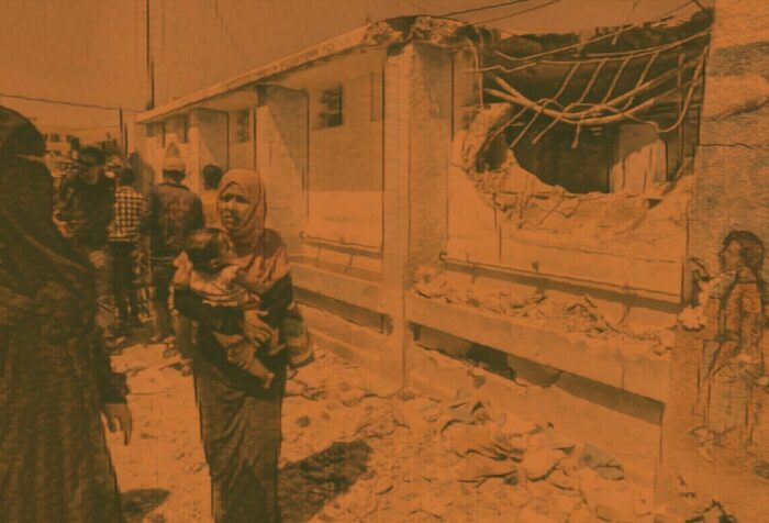 A photo of people on a street amidst rubble. Photo has an orange filter.
