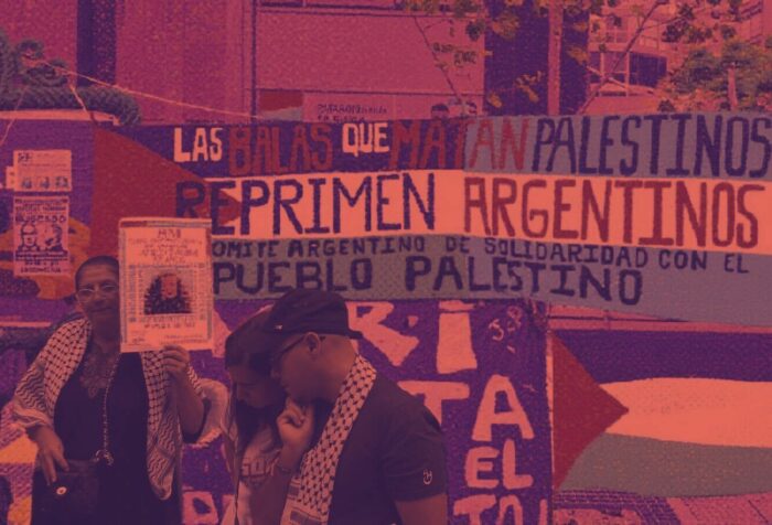 A photo of a protest for Palestine. Background: signs in Spanish and Palestine flags. Foreground: 3 people, 2 of whom are wearing keffiyehs.