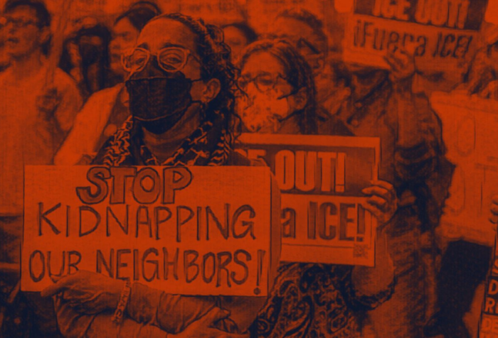 A close-up photo of a crowd holding anti-ICE signs. The photo has an orangish-red filter.