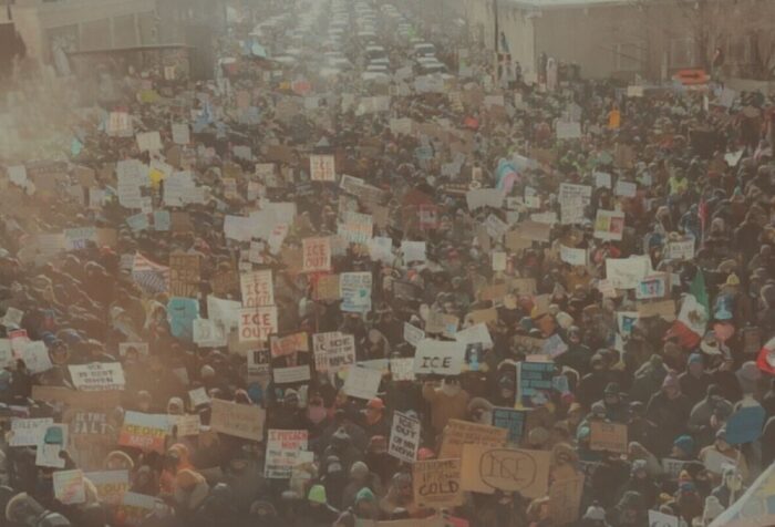 A photo of a crowd of anti-ICE protestors filling a street.
