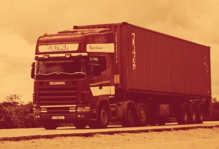 A photo of a semi truck driving down a road.
