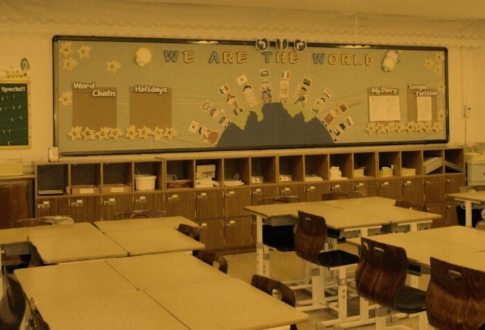 A yellow-filtered photo of an empty classroom.