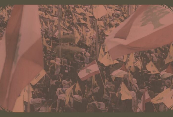 A crowd waves flags of Lebanon and Hezbollah.