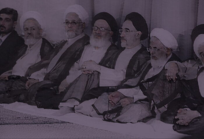 A purple-tinted photo of Iranian government officials sitting in a line.