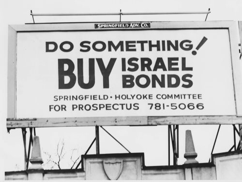 A billboard reading: “Do Something! Buy Israel Bonds. Springfield • Holyoke Committee for Prospectus 781-5066”