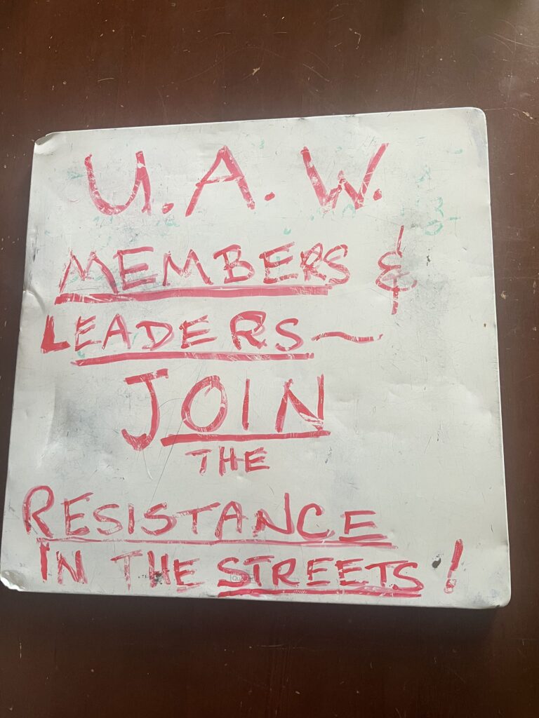 A sign that says "UAW members & leaders join the resistance in the streets!"