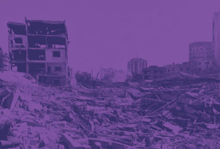 A purple-tinted photo of a rubbled city.